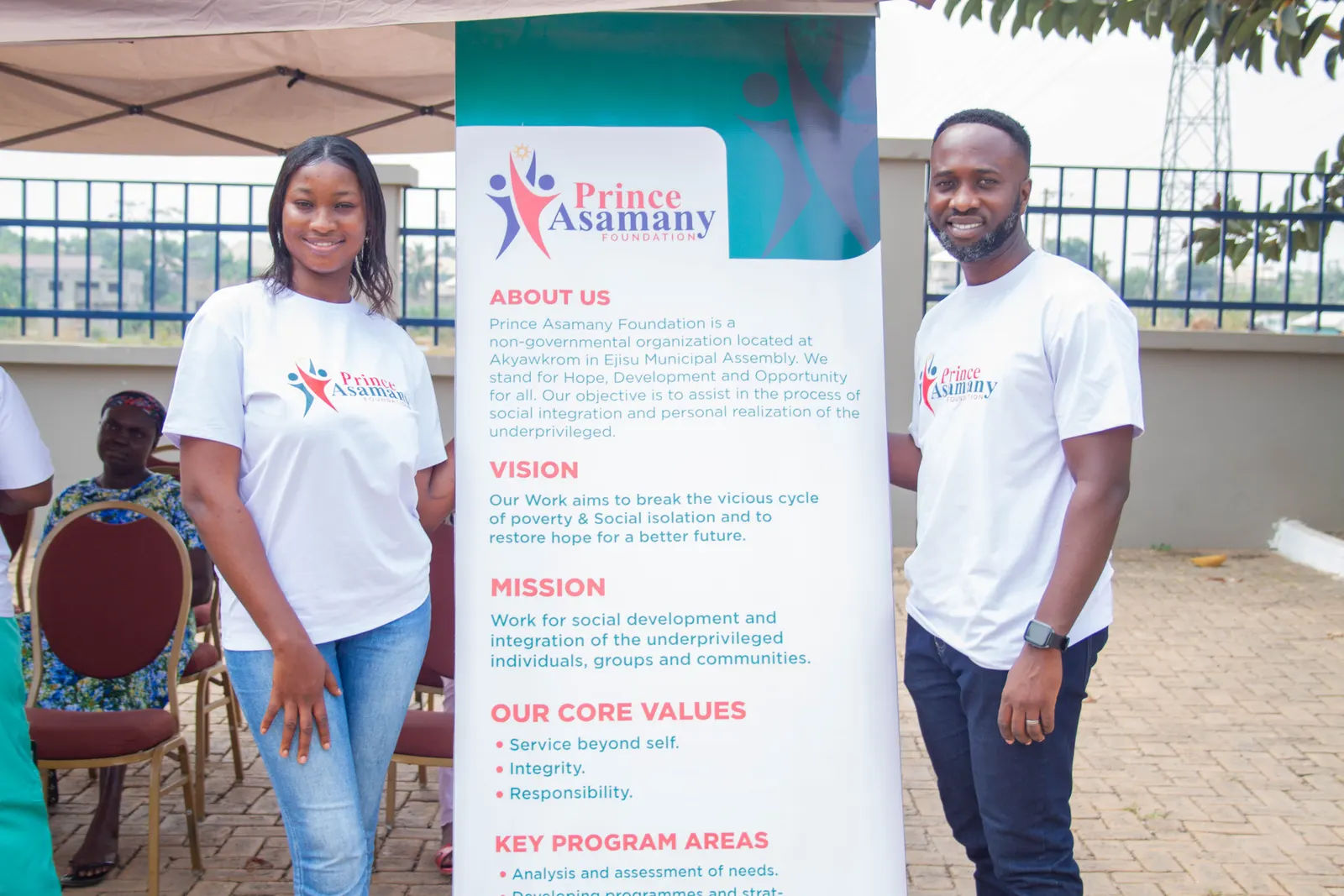 Foundation volunteers standing beside the foundation mission and vision banner during a community skills training event
